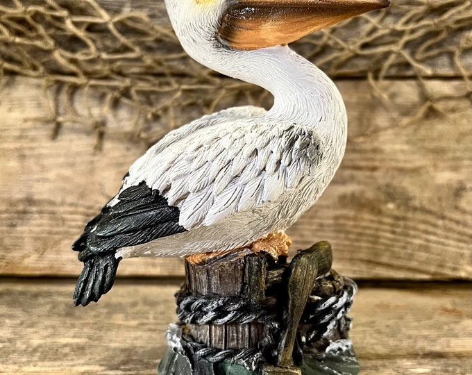 Hand-Painted Resin Coastal Pelican Perched On Pilings with Boat Oars and Nautical Rope Figurine