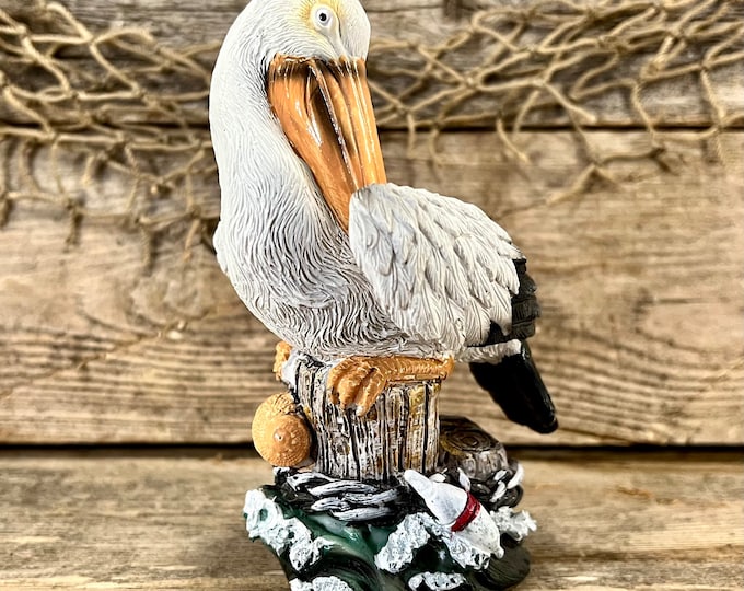 Hand-Painted Resin Coastal Pelican Perched On Pilings with Red and White Buoys Figurine