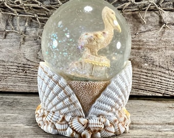 Pelican On Piling Sand and Seashells Resin and Glass Water Globe