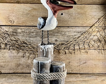 Handcrafted Coastal Wood Pelican Eating Fish On Pilings with Metal Legs and Rope Accent Statue