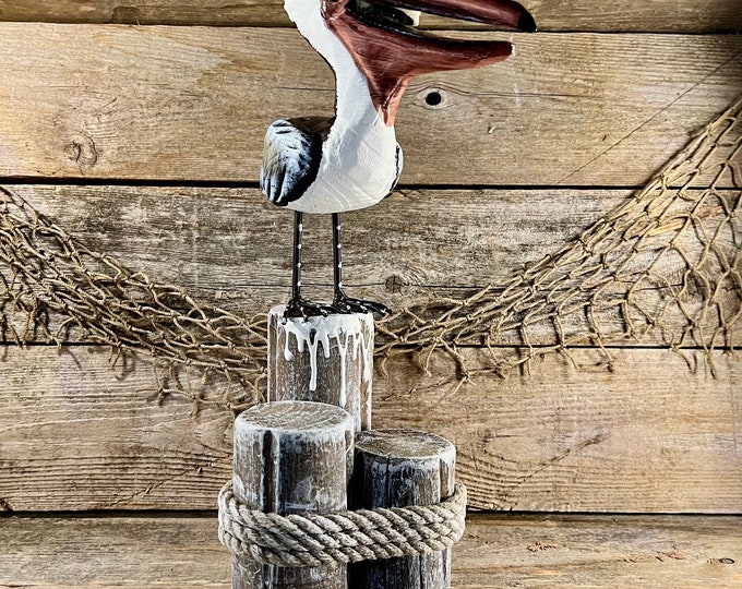Handcrafted Coastal Wood Pelican Eating Fish On Pilings with Metal Legs and Rope Accent Statue