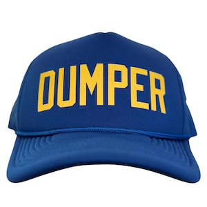 May include: A blue trucker hat with the word "DUMPER" in bold yellow letters across the front. The hat has a mesh back and a curved brim. The hat is a classic style, suitable for casual wear.