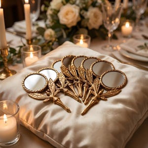 May include: A collection of small, round hand mirrors with gold-toned metal handles shaped like fairy figures with detailed wings. The mirrors are arranged in a cluster, each featuring a circular reflective glass surface and a decorative, textured handle.
