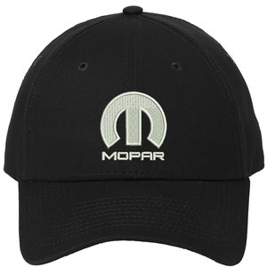 May include: Black baseball cap with a white embroidered Mopar logo. The logo features the Mopar symbol and the word "Mopar" underneath.