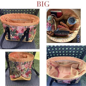 Op de afbeelding: Een grote tote bag met een bloemenpatroon in roze, rode en groene tinten. De tas heeft een gele basis, zwarte handvatten en een oranje interieur met meerdere vakken. Het woord "BIG" staat bovenaan.