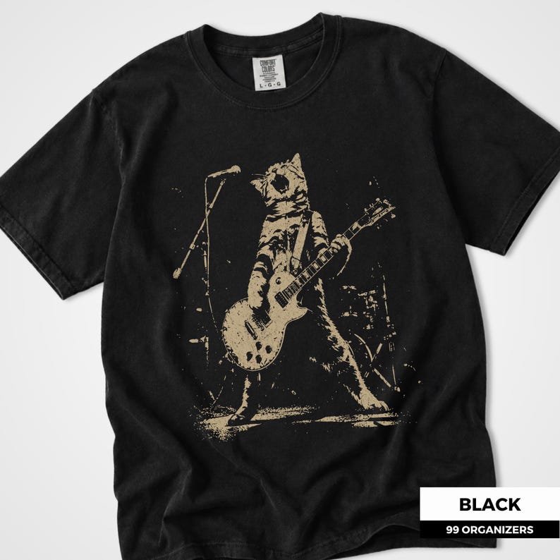 Punk cat design featuring a fierce tabby cat standing onstage while playing an electric guitar beneath a microphone. The distressed monochrome artwork captures the energy of a live rock performance with grunge texture, bold movement, and vintage concert poster style. A striking graphic for cat lovers, guitar players, alternative music fans, punk rock enthusiasts, and shoppers seeking edgy band-inspired apparel.