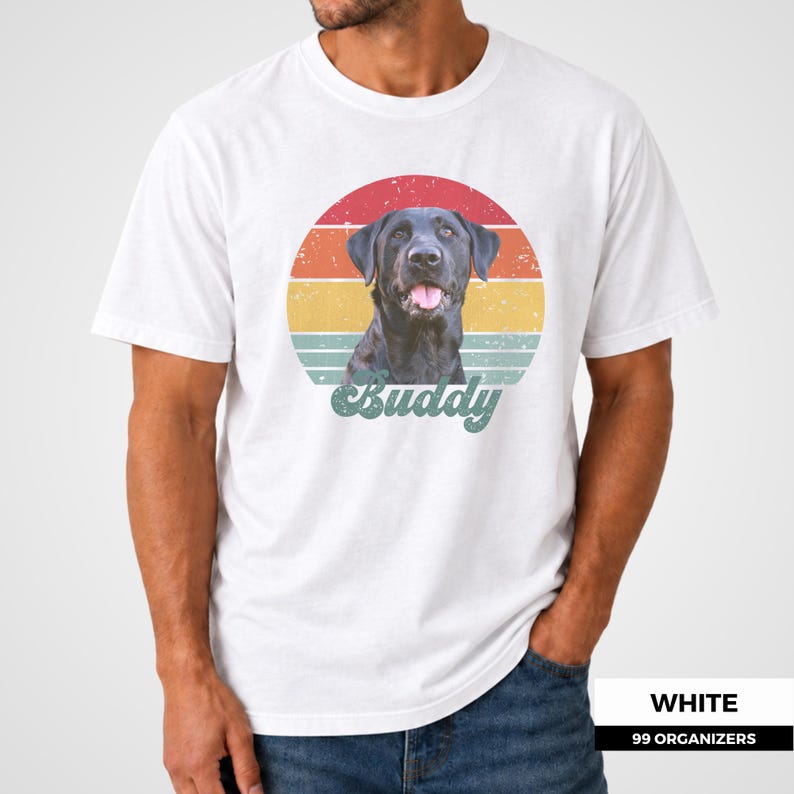 Custom pet shirt featuring a personalized dog or cat portrait in front of a colorful distressed sunset inspired by vintage 1970s graphics. Warm red, orange, yellow, and teal bands frame the pet, while a large custom name in retro script completes the design. A meaningful pet photo gift for dog moms, dog dads, cat parents, birthdays, holidays, memorial keepsakes, adoption anniversaries, and anyone who wants a personalized portrait of a beloved animal.
