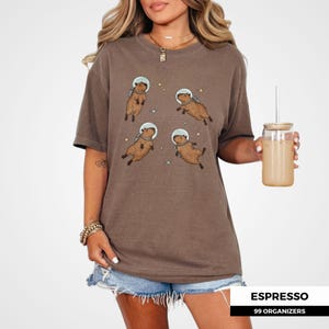Capybara print tee for meme t-shirt collectors and quirky fashion lovers. Vintage-style space shirt with a playful twist. Great gift for capybara moms, rodent enthusiasts, or space geeks who love expressive, fun designs.