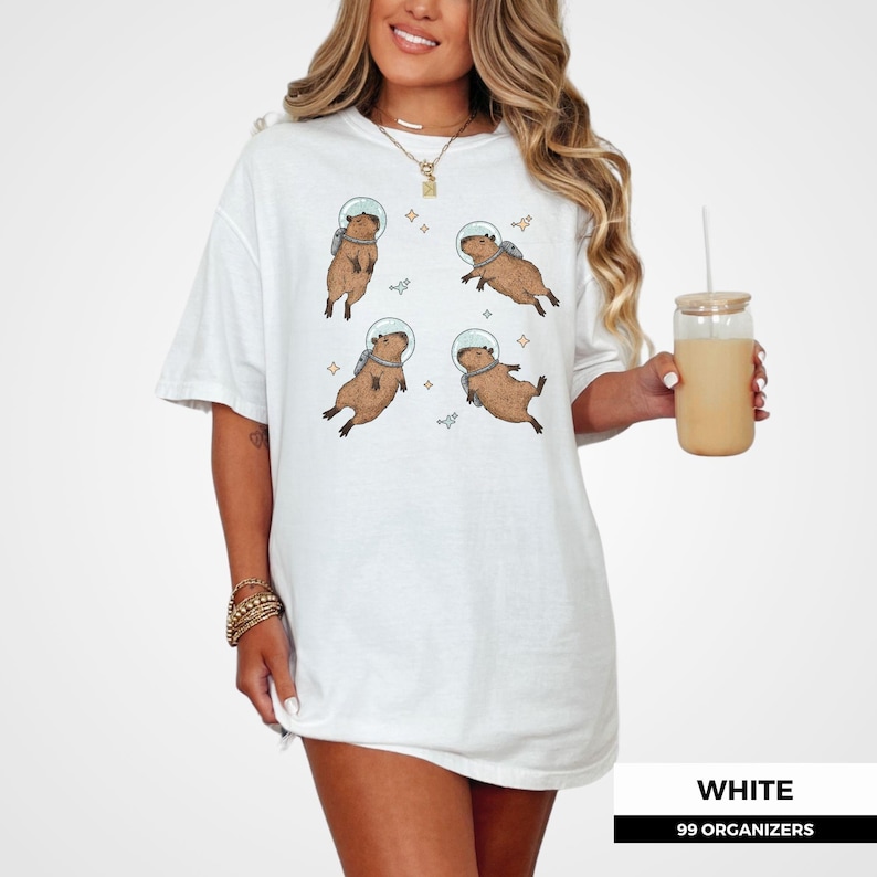 Funny capybara t-shirt with astronaut theme. Unique animal graphic for fans of outer space, weird animal humor, and offbeat fashion. Great gift for cowboys at heart, science nerds, or anyone who loves cute rodent designs.