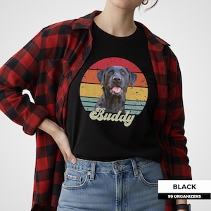 Personalized dog photo shirt featuring a custom pet portrait against a colorful vintage sunset made from distressed retro stripes. A large script pet name sits below the portrait for a bold personalized finish. This nostalgic custom pet design can be created from a favorite dog or cat photo and makes a thoughtful gift for pet owners, dog moms, dog dads, cat lovers, birthdays, holidays, pet memorials, and anyone celebrating a beloved companion.