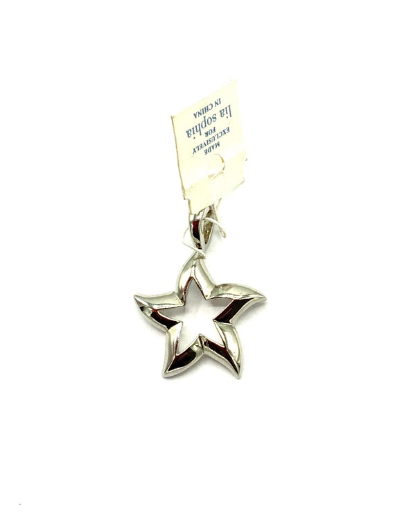 Gorgeous collectible silver tone star pendant by Lia Sophia.