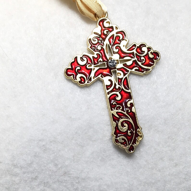 Gold tone Cross with red enamel pendant.