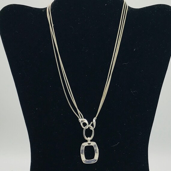 Silver tone and multiple chain with a pendant by … - image 3
