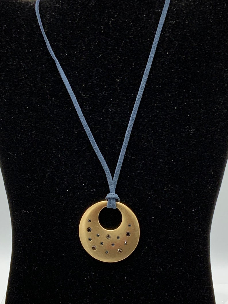 Round Gold tone with rhinestone with blue lace necklace by Lia Sophia.