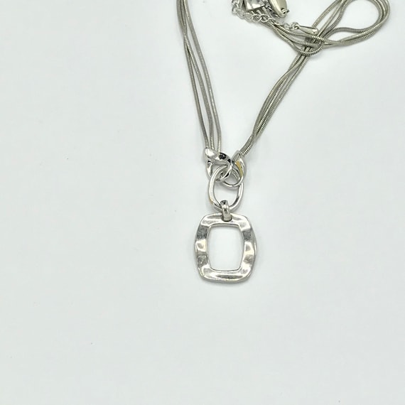 Silver tone and multiple chain with a pendant by … - image 1