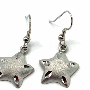 Gorgeous collectible star silver tone, hoop earrings by Cookie Lee.