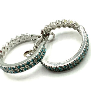 Gorgeous collectible and vintage light blue rhinestone round earring by Lia Sophia and  silver tone.