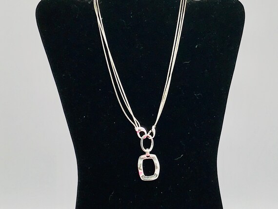 Silver tone and multiple chain with a pendant by … - image 2