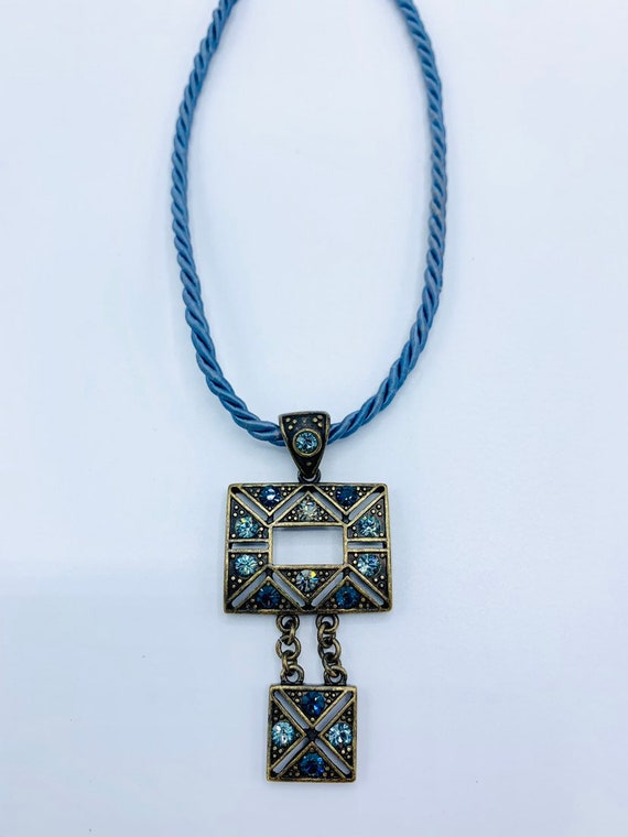 Gorgeous collectible and vintage Lia Sophia blue light and brass tone necklace with rhinestone. New with tag. View 3
