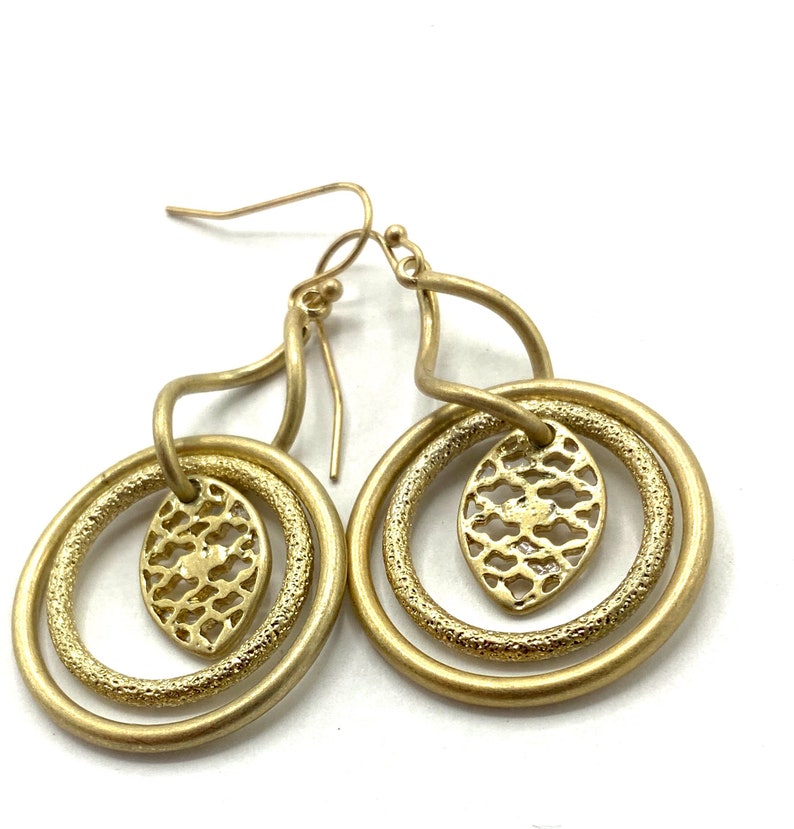 Gorgeous collectible and vintage old gold tone earrings by Lia Sophia, hoop, carved, round. image 1