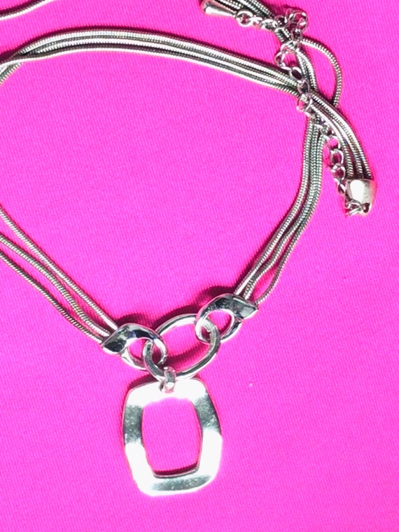 Silver tone and multiple chain with a pendant by … - image 9