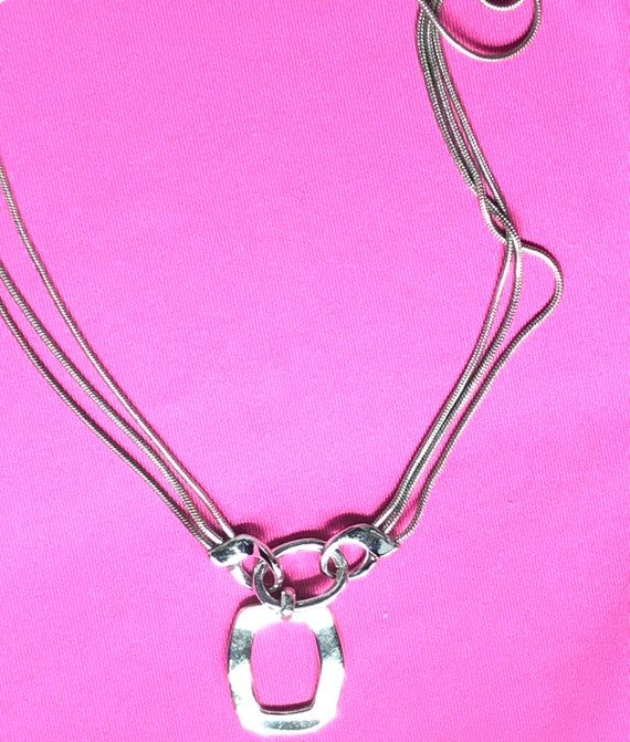 Silver tone and multiple chain with a pendant by … - image 10