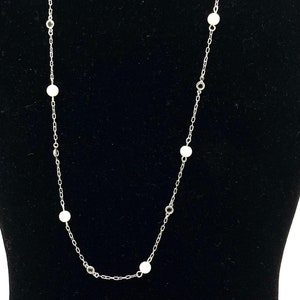 Gorgeous collectible and vintage white pearls and Clear crystal necklace by Lia Sophia. Silver tone, signed.