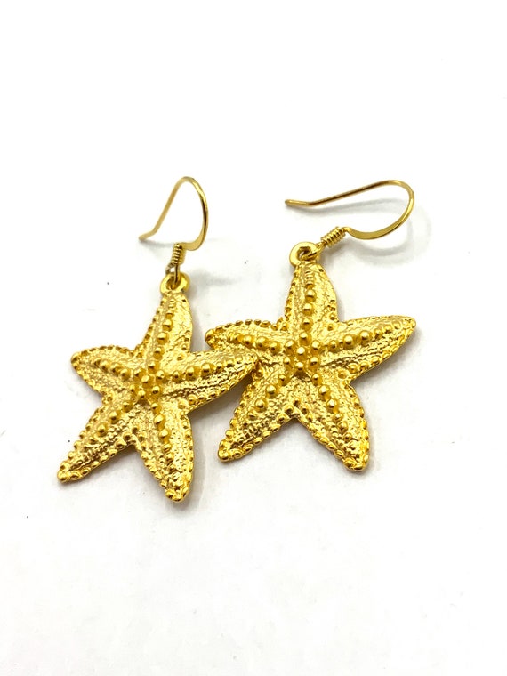 Gorgeous collectible gold tone star hoop earrings by Cookie Lee.