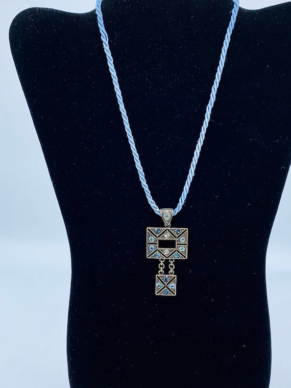 Gorgeous collectible and vintage Lia Sophia blue light and brass tone necklace with rhinestone. New with tag.