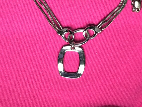 Silver tone and multiple chain with a pendant by … - image 7