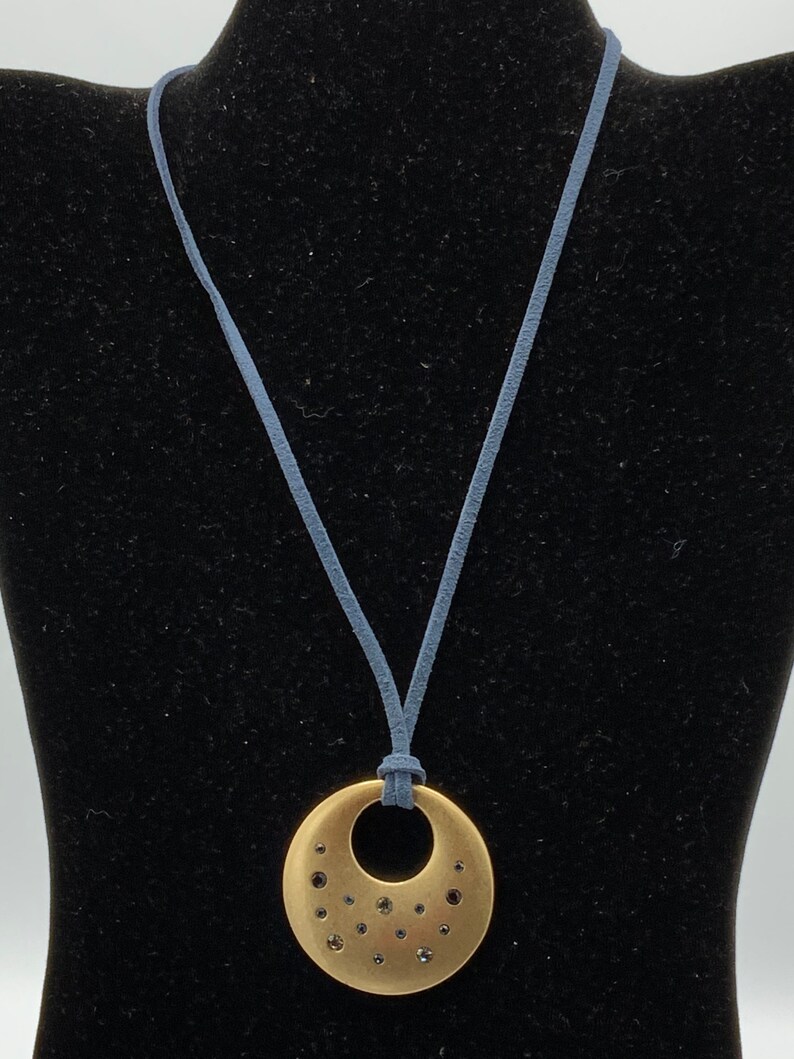 Round Gold tone with rhinestone with blue lace necklace by Lia Sophia.