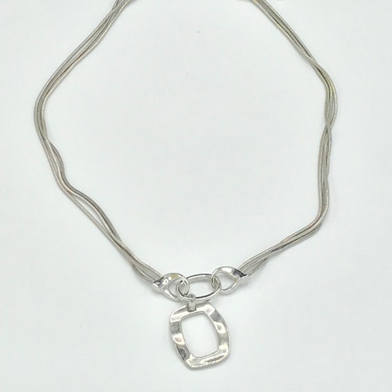 Silver tone and multiple chain with a pendant by … - image 4
