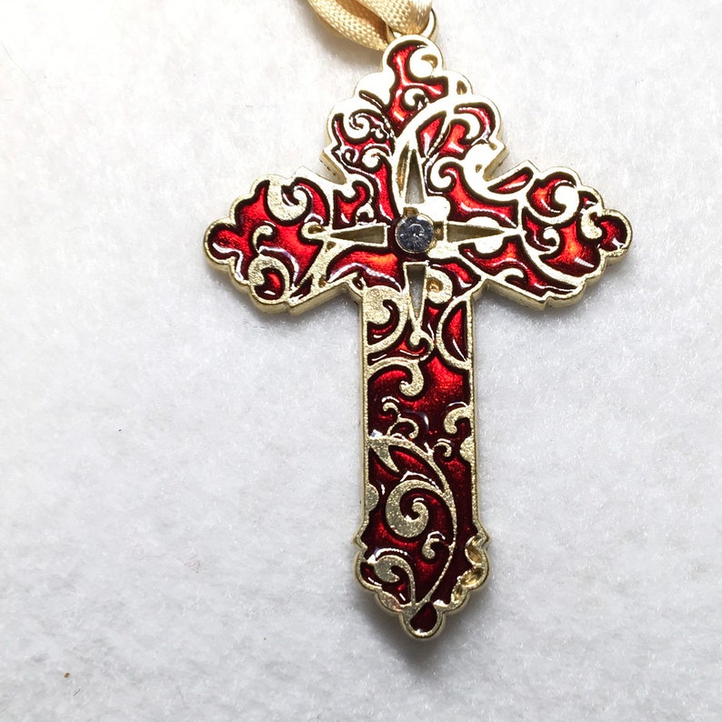 Gold tone Cross with red enamel pendant.
