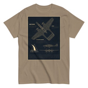 May include: A tan t-shirt with a blue and gold graphic of a Northrop P-61 Black Widow aircraft. The graphic includes the text "Northrop" and "P-61 Black Widow".