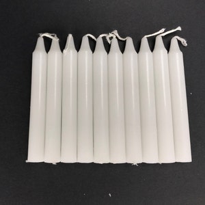 May include: A set of ten white taper candles, each approximately 6 inches long.