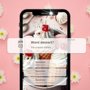 以下が含まれることがあります： スマートフォン画面にはデザートをテーマにした通知が表示されています。画面には、アイスクリームコーン、チェリー、メレンゲが表示されています。通知には「デザートが欲しいですか？」と表示され、ワッフルコーン、グラッセチェリー、ピンクメレンゲのリマインダーが表示されています。