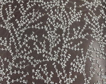 May include: White beaded fabric with a delicate floral pattern. The beads are small and evenly spaced, creating a subtle shimmer.