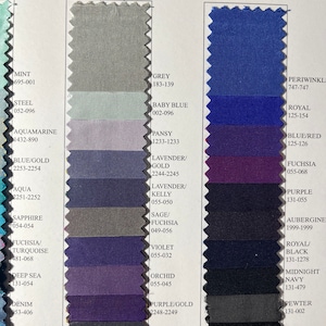 May include: A color chart with fabric swatches in various shades of blue, purple, green, and grey. Each swatch is labeled with a color name and a corresponding number code.