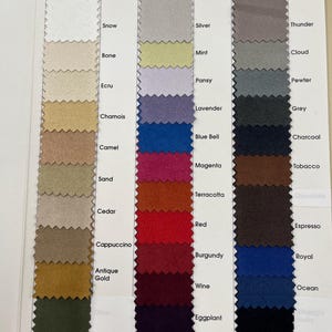 May include: Color swatch card featuring a variety of fabric samples in a range of colors. The swatches are arranged in columns, with each swatch labeled with a color name. Colors include Snow, Silver, Thunder, and Black.