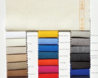 May include: A fabric swatch card with 20 different color swatches. The card is labeled "Crepe Suzette" and "58/60" Wide 100% Superfine Wool IMPORTED". The colors include snow white, ivory, beige, tan, mocha, hazelnut, falcon brown, java, concord grape, bold yellow, aquamarine, electric blue, blue grass, orange, magenta, santa red, grape, cherry, bordeaux, pearl gray, greystone, ash heather, heather heather, charcoal, varsity blue, hale navy, midnight navy, and black.