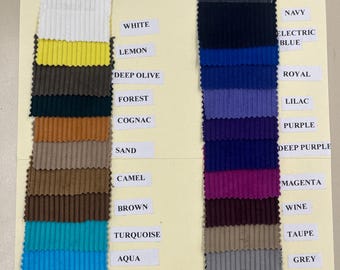 May include: A color chart of 16 different corduroy fabric swatches, each measuring 58 inches wide. The swatches are arranged in two columns, with the colors labeled on the right side. The colors include white, lemon, deep olive, forest, cognac, sand, camel, brown, turquoise, aqua, sky blue, navy, electric blue, royal, lilac, purple, deep purple, magenta, wine, taupe, grey, and black.