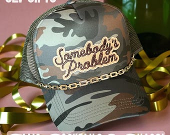 Somebody’s Problem Trucker Hat | Camo Hat | Country Concert Hat | Girls Trip Hat | Glam Cowgirl Hat | Sassy Gift for Her | CLV Gifts