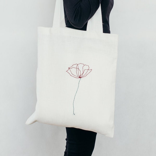 Linen shopping bag with smart pocket, natural and solid ,embroidered one-line drawing poppy flower. Colour: ecru.