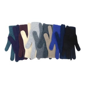 May include: A collection of knitted gloves arranged in a row, featuring a variety of solid colours including teal, dark purple, burgundy, cream, light grey, charcoal, beige, royal blue, navy, and black, each with a ribbed cuff at the wrist.
