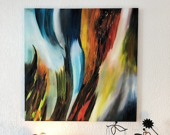 May include: A square abstract painting featuring bold, sweeping brushstrokes in shades of blue, orange, yellow, and black. Below the artwork sits a wooden sideboard with a small spider-shaped lamp and two black metal wire figurines.