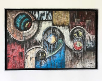 May include: A rectangular abstract painting in a black frame featuring a large blue and brown circular eye-like form, a central sphere, and two smaller stacked circles on the right. The composition uses textured red, blue, and gold blocks.