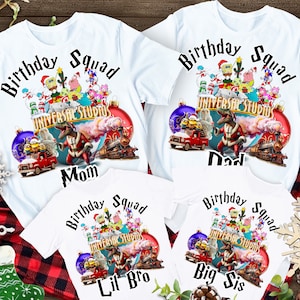 May include: White t-shirts with a Christmas-themed graphic featuring cartoon characters from Universal Studios. The shirts have the text "Birthday Squad" and "Universal Studios" on them. The shirts are labeled "Mom", "Dad", "Lil Bro", and "Big Sis".