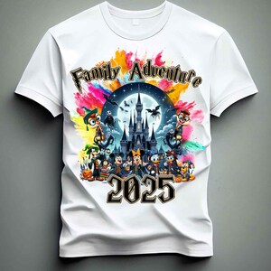 May include: White t-shirt with a colorful graphic of a castle, Mickey Mouse, and other Disney characters. The text "Family Adventure 2025" is printed on the shirt.