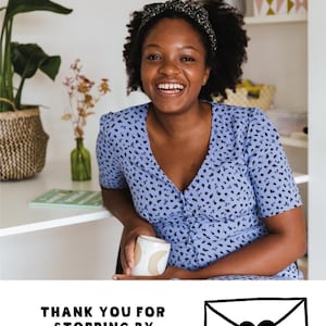 May include: A woman wearing a blue dress with a black and white patterned headband smiles while holding a mug. The text "THANK YOU FOR STOPPING BY" is displayed below the woman, along with an envelope graphic.