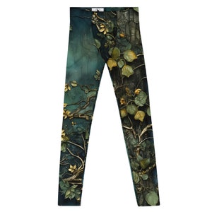 May include: A pair of dark green leggings with a forest-themed print. The print features branches, leaves, and a textured bark-like pattern in shades of green, brown, and gold.